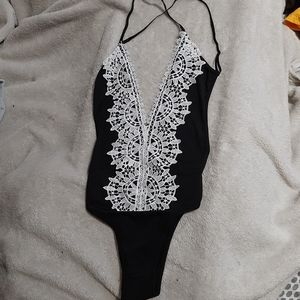 backless plunge neckline cross strapped bodysuit.